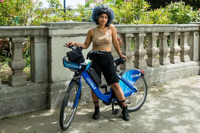 A woman rides takes a break from riding her Citi Bike on Memorial Day Weekend, 2020. The program got off to a shaky start one decade ago.